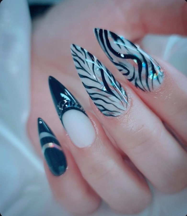 Stiletto nails mixing black gloss, black French and clear zebra-stripe art