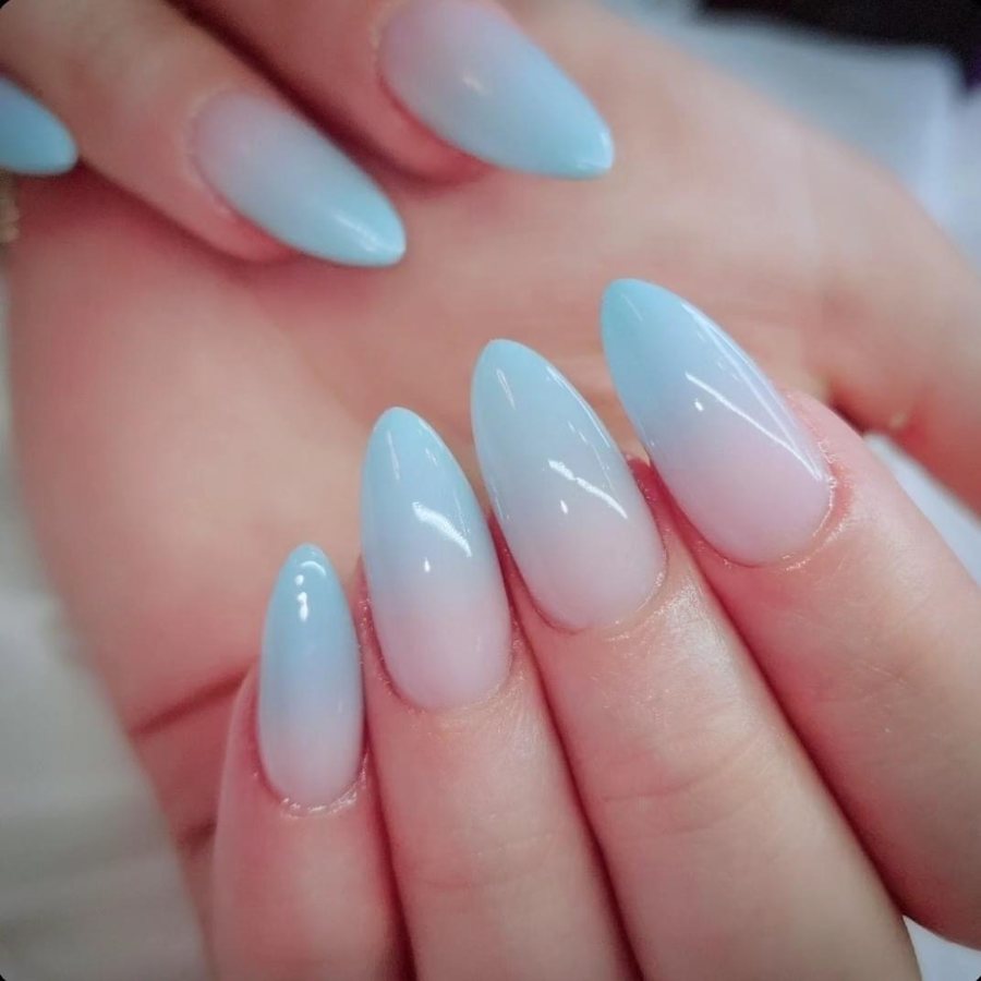 Almond nails with a soft pink to baby blue ombre