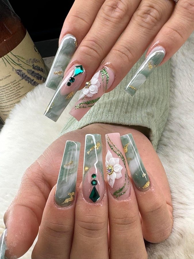 Long square nails with jade green marble, gold flakes, emerald gems and a 3D white flower